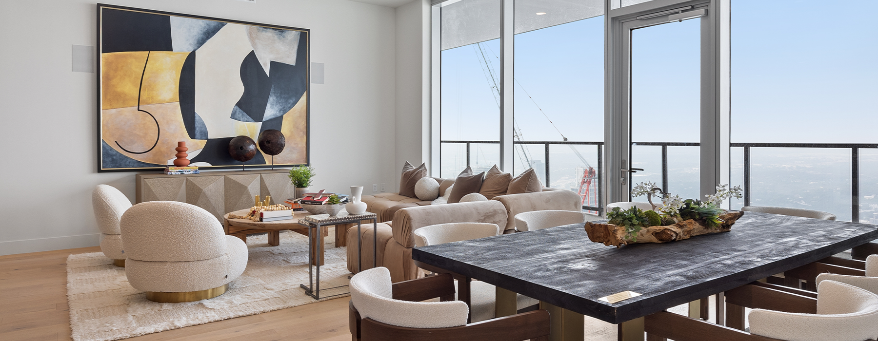 Spacious and well lit living room with wood floors and a large windows